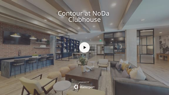 A modern clubhouse interior with a bar area and seating.