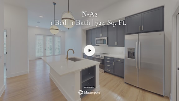 A kitchen with a white countertop and a sink, and a refrigerator with a stainless steel finish.
