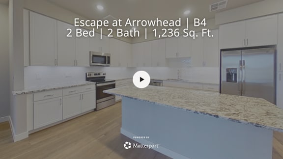 A kitchen with a video play button overlay.