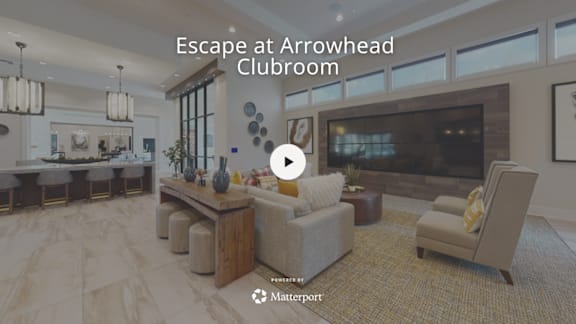 A spacious clubroom with a bar area and a fireplace.