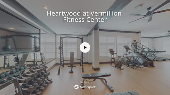 A fitness center with a variety of equipment including treadmills, weights, and exercise machines.