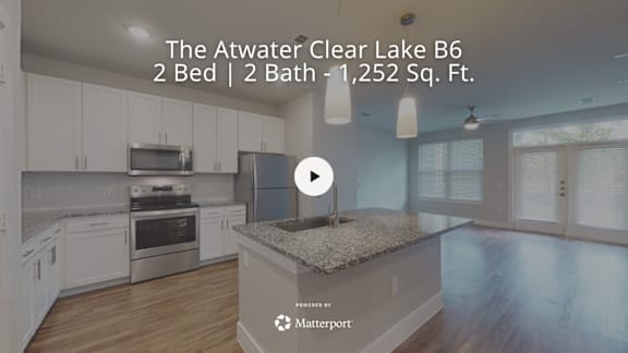 A kitchen with a play button overlay.