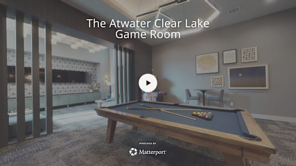 A room with a pool table and a television.