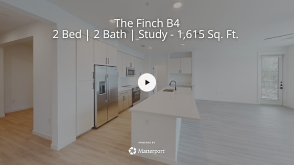 A kitchen with a refrigerator, cabinets, and a countertop is shown in a property listing for The Finch B4.