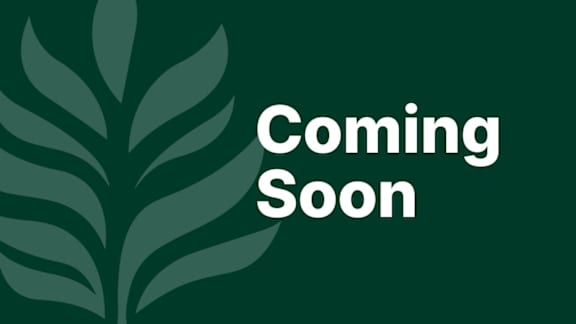 A green sign with a white leaf and the words "Coming Soon".