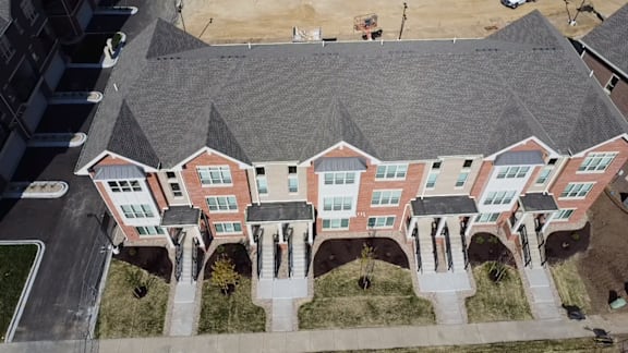 an aerial view of a large house with a roof that is gray
