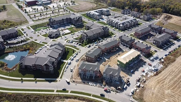 an aerial view of a city with houses and roads