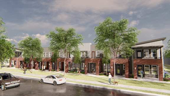 a rendering of a development of townhouses on a street with cars