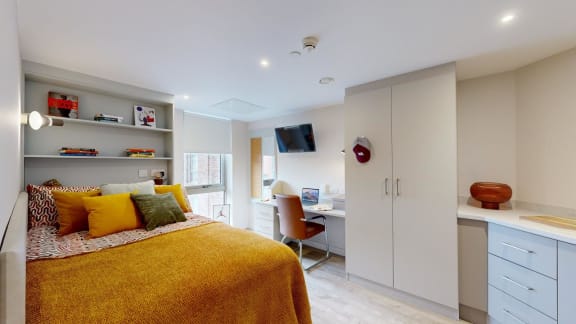 a bedroom with a bed and a desk