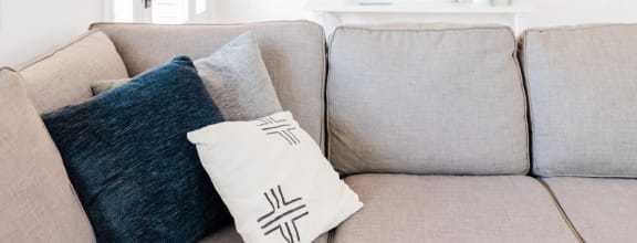 a couch with pillows on it in a living room