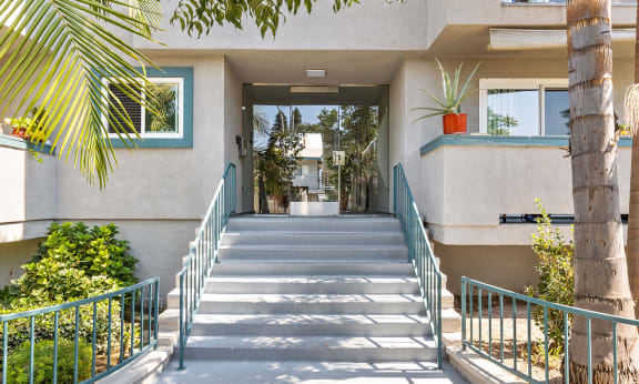 the stairs up to an apartment building with a staircase