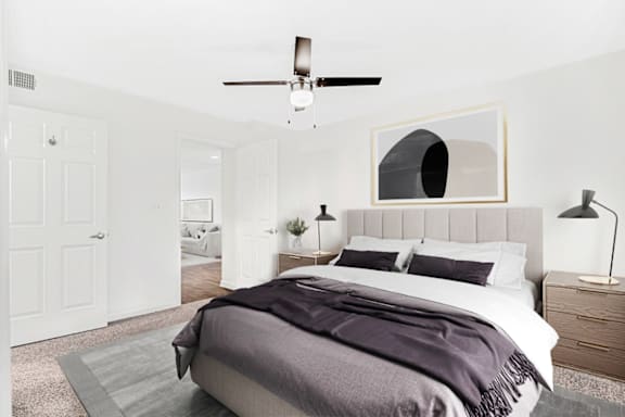 a bedroom with a bed and a ceiling fan at Caveness Farms Apartments, Wake Forest, NC