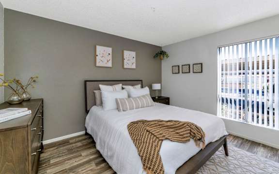 a bedroom with a large bed and a ceiling fan
