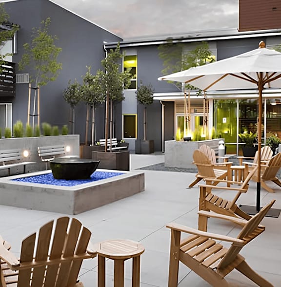 A modern outdoor seating area with wooden chairs and tables.