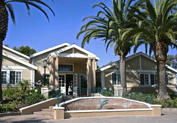 A house with a front yard and palm trees at The Villas at Monarch Beach, Dana Point, California