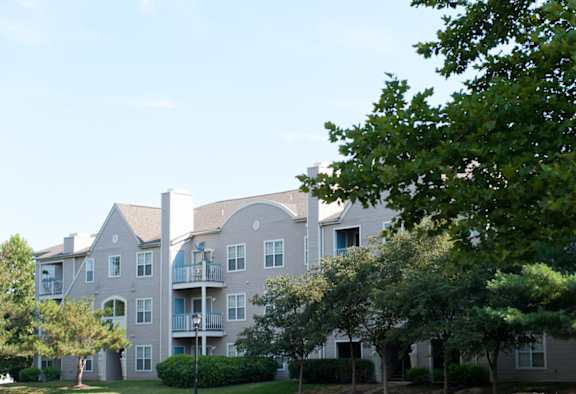 the view of an apartment building with trees