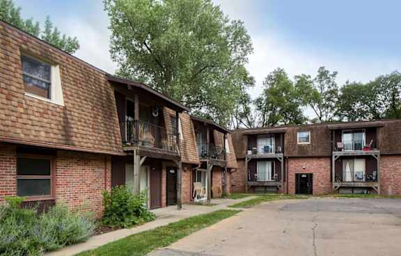 Apartment complex with brick buildings and balconies.