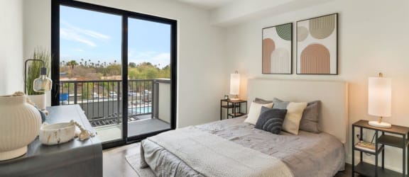 a bedroom with a large window and a ceiling fan at  The Common Apartments, Phoenix, Arizona, 85018