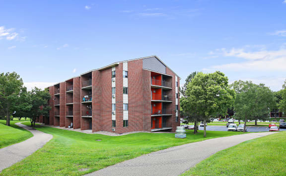 a red brick apartment building with balconies at Twelve 501 Apartment Homes, Burnsville