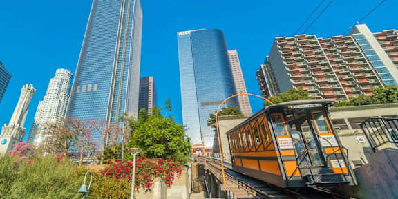 A cityscape with a tram in the foreground.