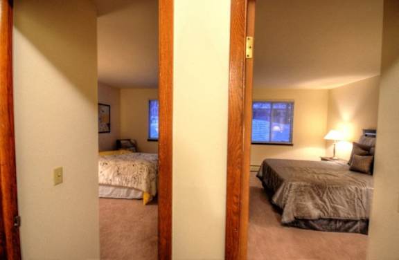 a bedroom with two beds and a window