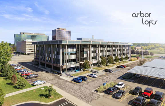 A parking lot with cars and a building in the background.