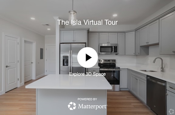A kitchen with a play button overlay and text that reads "The Isla Virtual Tour" and "Explore 3D Space".