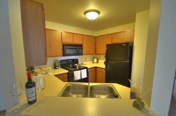 a kitchen with a sink and a refrigerator