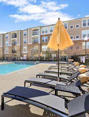 our apartments have a large pool with lounge chairs and umbrellas