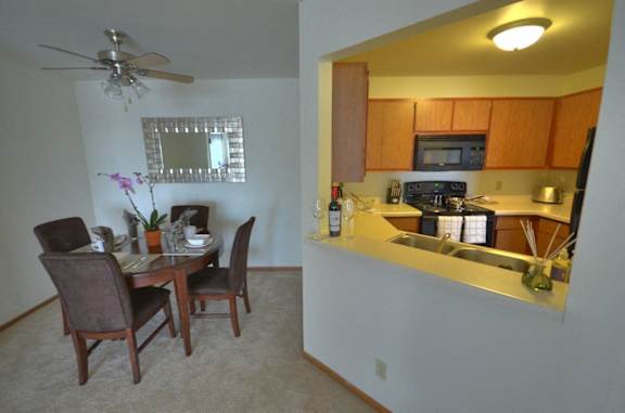 a view of a kitchen and a dining room with a table