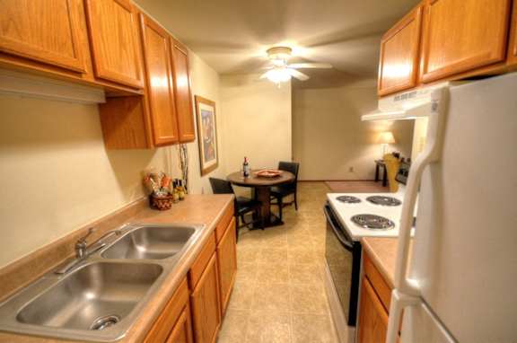 a kitchen with wooden cabinets and stainless steel appliances