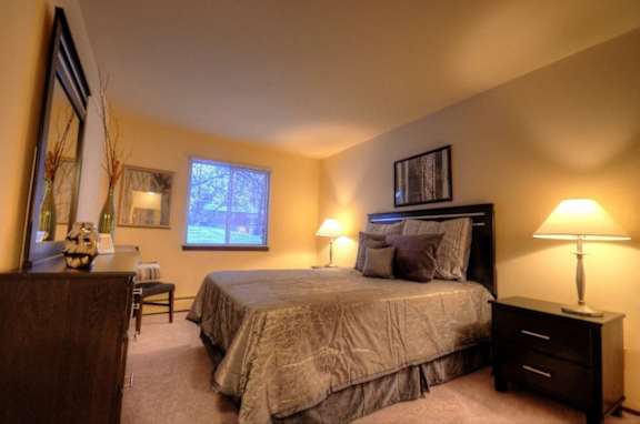 a bedroom with a large bed and a desk