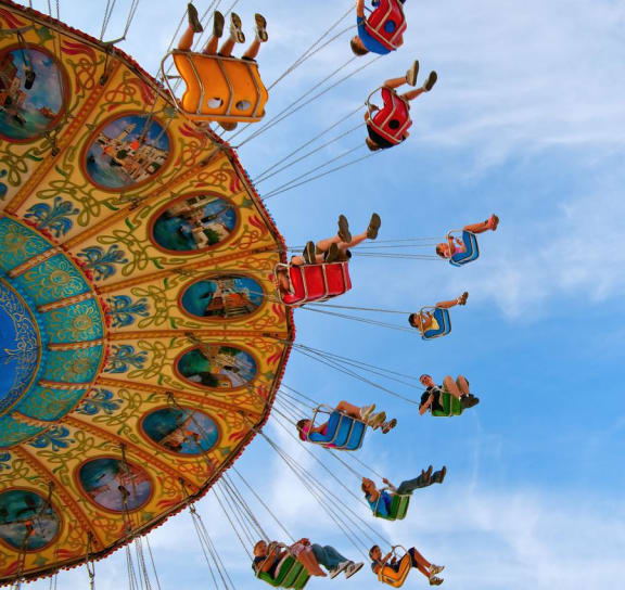 people riding on a ferris wheel at an amusement park
