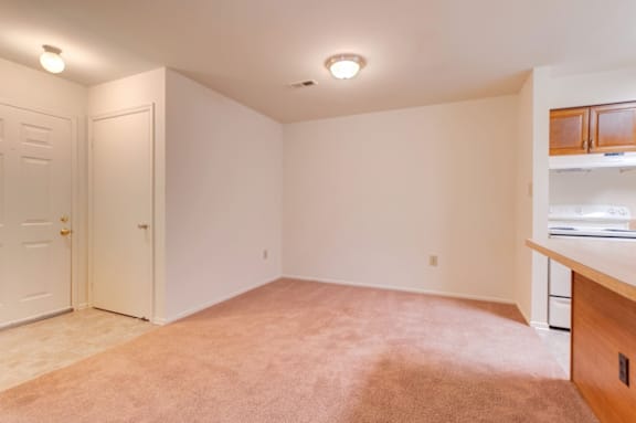 Entryway with coat closet opening up to the dining room and kitchen.