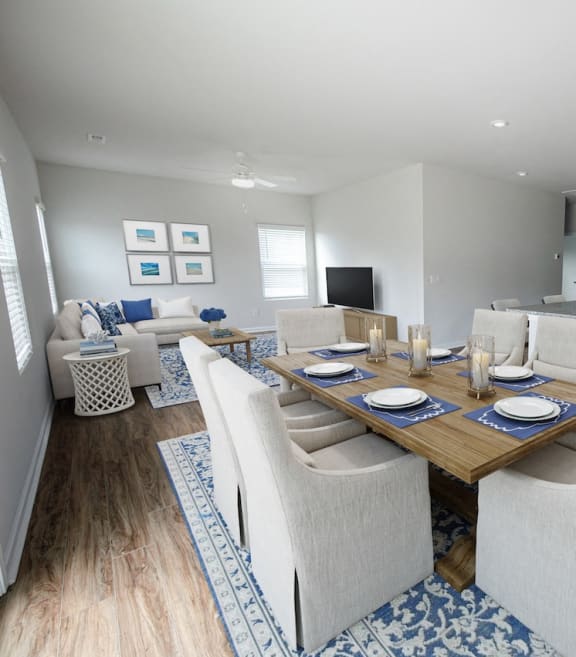 a dining room and living room with a table and chairs
