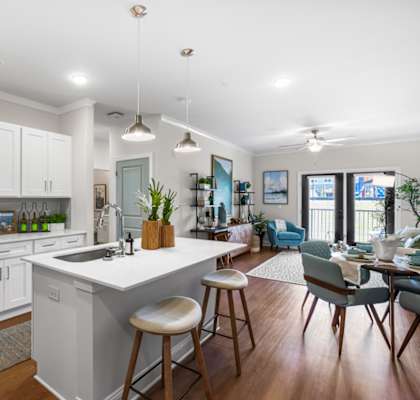 A modern kitchen with a large island and bar stools.