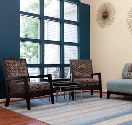 a living room with a couch and chairs and a table