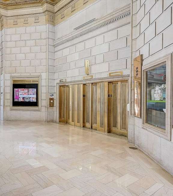 A large, empty lobby with marble floors and white walls. at Lofts at 629, Ohio, 44114