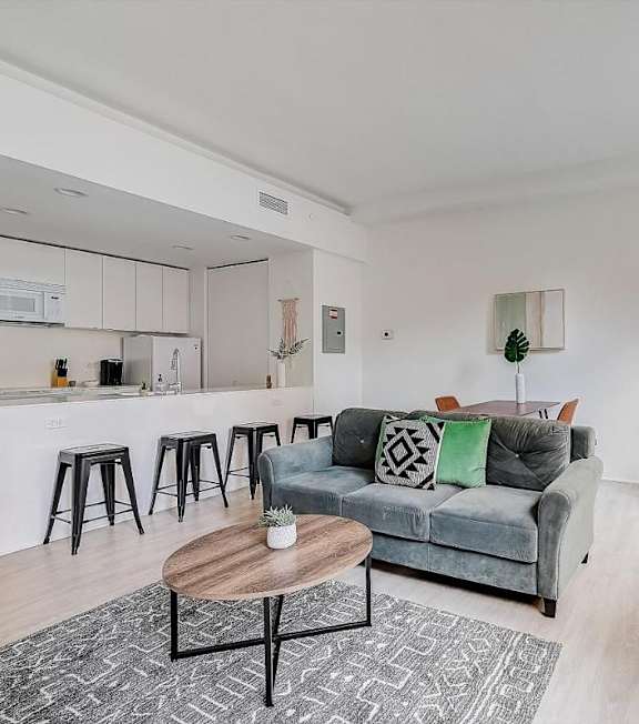 A living room with a grey couch and a coffee table. at Lofts at 629, Ohio, 44114