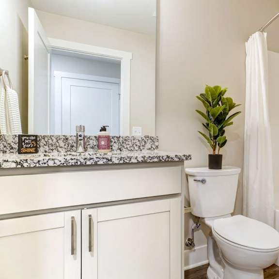 Two white front loading washing machines in a laundry room. at Eden Forest Townhomes Apartments, Kentwood , 49508