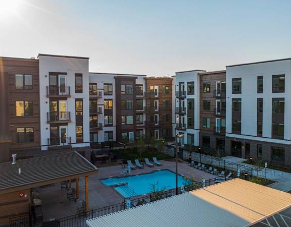 Meritage West Apartments in Boise, Idaho Exterior and Pool with Lounge Chairs