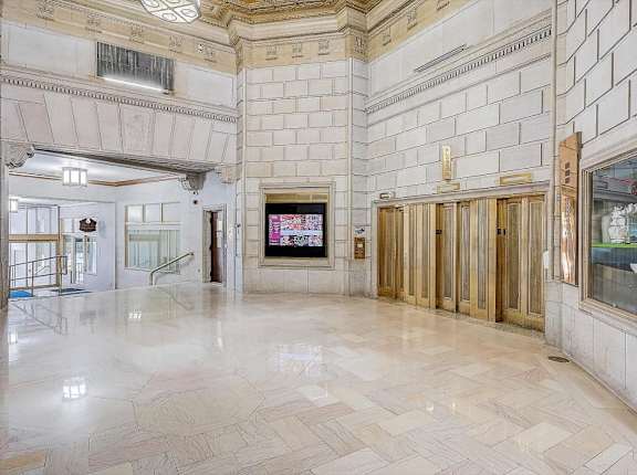 the lobby of the building has marble floors and wooden doors at Lofts at 629, Ohio, 44114