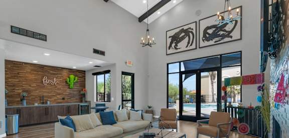 A modern living room with a wooden floor and a large window.
