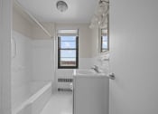 Thumbnail 11 of 20 - a white bathroom with a tub and a sink