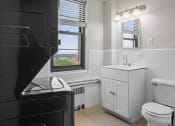 Thumbnail 14 of 20 - a bathroom with a sink toilet and a window