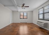 Thumbnail 5 of 20 - an empty living room with a ceiling fan and a window
