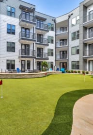 a putting green in the middle of an apartment building