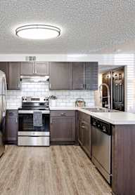 a kitchen with wooden cabinets and stainless steel appliances