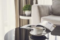 a cup of coffee on a table in a hotel room