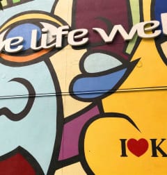 a mural on the side of a building with the words live life well